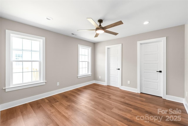 640 Central Dr NW, Concord, NC 28027 - unfurnished bedroom featuring visible vents, wood finished floors, baseboards, ceiling fan, and recessed lighting