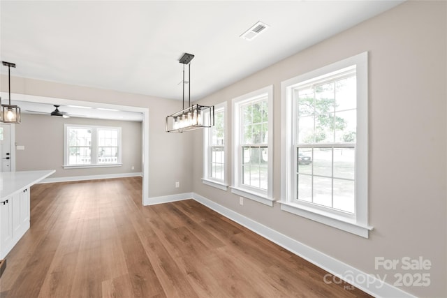640 Central Dr NW, Concord, NC 28027 - unfurnished dining area with a ceiling fan, baseboards, visible vents, and wood finished floors