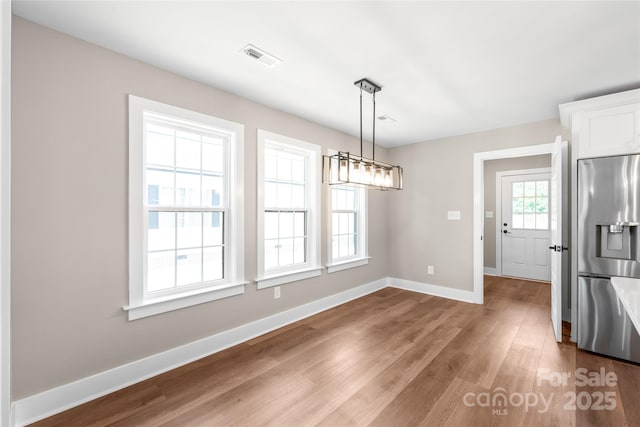 640 Central Dr NW, Concord, NC 28027 - unfurnished dining area featuring baseboards, wood finished floors, and visible vents