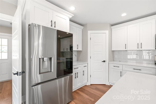 640 Central Dr NW, Concord, NC 28027 - kitchen featuring white cabinets, light wood-style flooring, recessed lighting, backsplash, and stainless steel refrigerator with ice dispenser