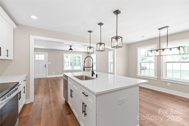 640 Central Dr NW, Concord, NC 28027 - kitchen with a sink, appliances with stainless steel finishes, hanging light fixtures, and wood finished floors