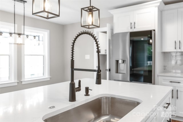 640 Central Dr NW, Concord, NC 28027 - kitchen with a sink, stainless steel fridge with ice dispenser, white cabinets, and decorative light fixtures
