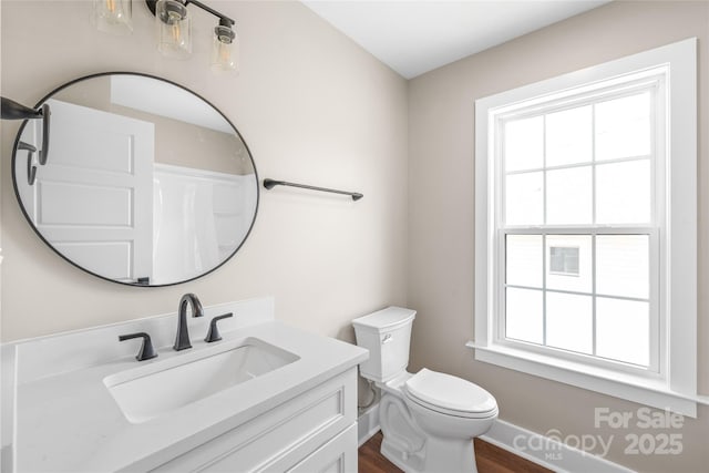 640 Central Dr NW, Concord, NC 28027 - bathroom with vanity, baseboards, toilet, and wood finished floors