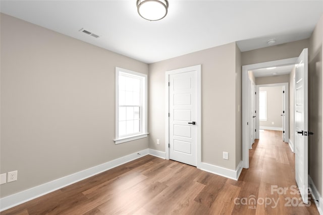 640 Central Dr NW, Concord, NC 28027 - unfurnished bedroom with visible vents, baseboards, and wood finished floors