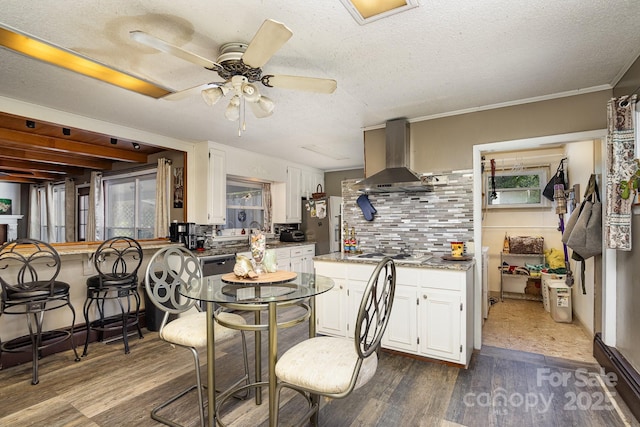 dining area featuring a textured ceiling, ceiling fan, and dark wood finished floors