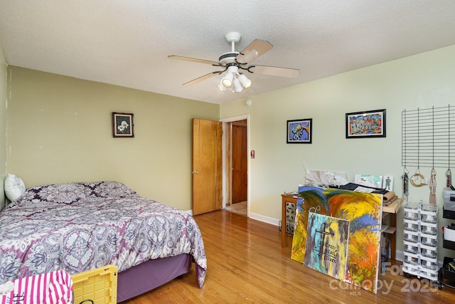 bedroom with ceiling fan and wood finished floors