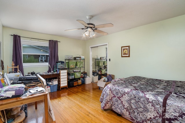 bedroom with light wood finished floors and a ceiling fan