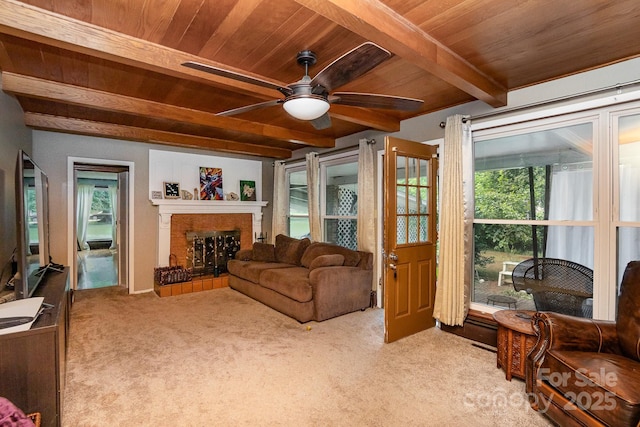 carpeted living room with a fireplace, a ceiling fan, wooden ceiling, and beamed ceiling