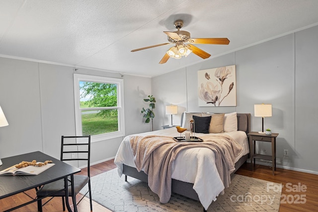 bedroom featuring ornamental molding, ceiling fan, and wood finished floors