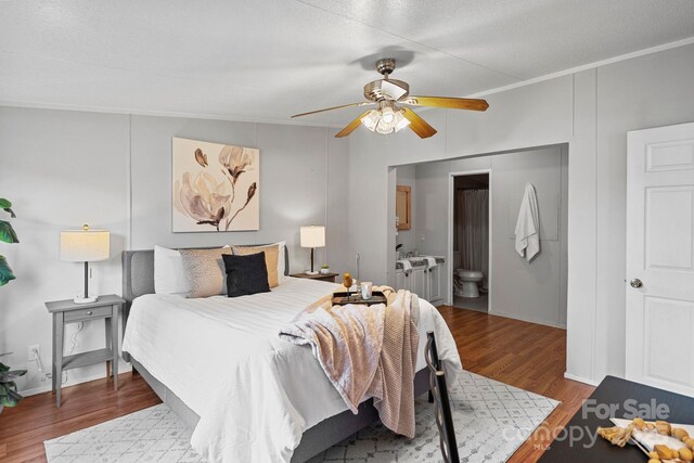 bedroom with a ceiling fan, ornamental molding, wood finished floors, and ensuite bathroom