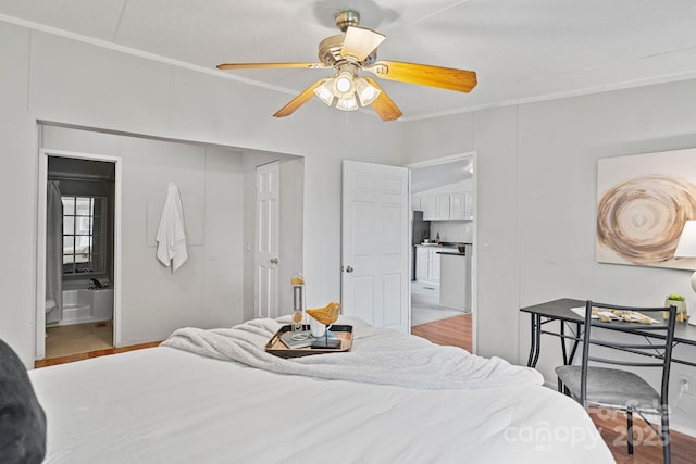 bedroom with ensuite bathroom, ornamental molding, ceiling fan, and wood finished floors