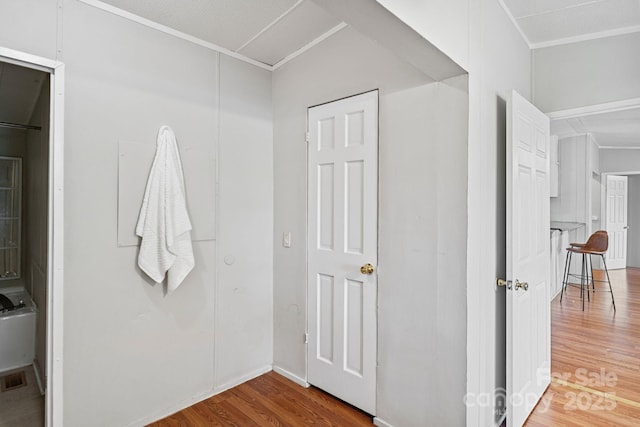 interior space featuring crown molding, wood finished floors, and visible vents