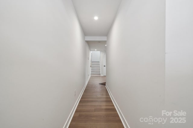 hallway with stairway, recessed lighting, dark wood-style floors, and baseboards