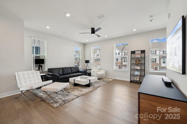 living room with recessed lighting, wood finished floors, baseboards, visible vents, and a ceiling fan