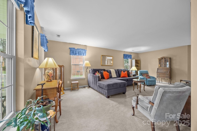 living area featuring visible vents, carpet flooring, and baseboards
