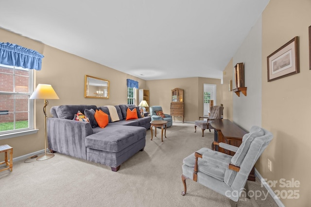 living room featuring light carpet and baseboards