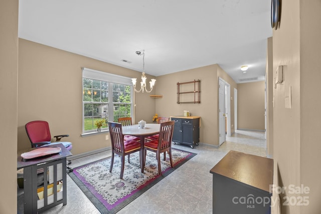 dining room with baseboards, visible vents, and a notable chandelier