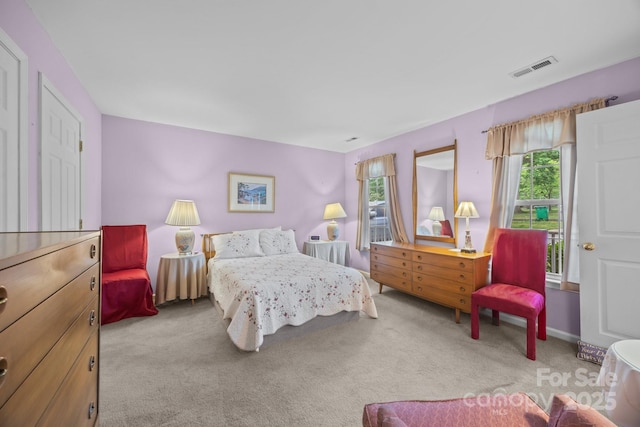 bedroom with visible vents and carpet