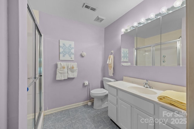 bathroom featuring visible vents, a shower with door, and vanity