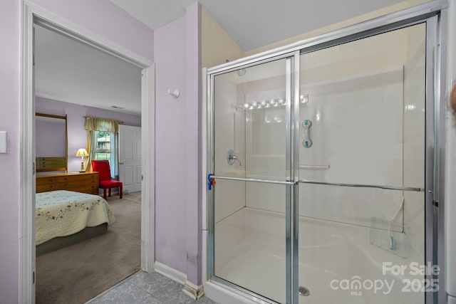 ensuite bathroom with baseboards, a stall shower, and ensuite bathroom