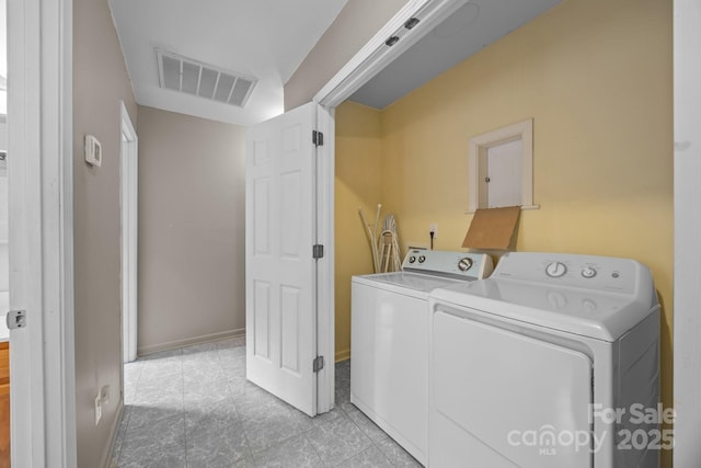 laundry room with light tile patterned floors, visible vents, separate washer and dryer, and laundry area