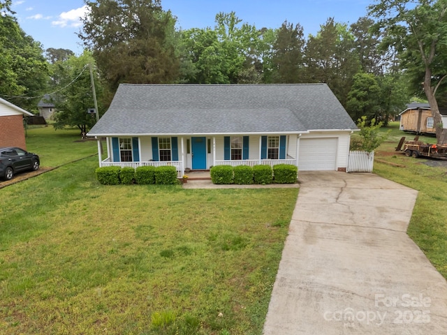 view of front of house with a front lawn, a shingled roof, covered porch, concrete driveway, and an attached garage
