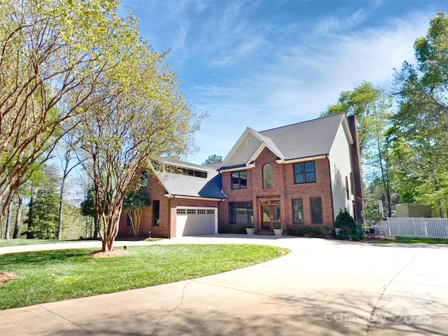484 Chisholm Trl, Rutherfordton, NC 28139 - colonial-style house with driveway, fence, a front lawn, and brick siding