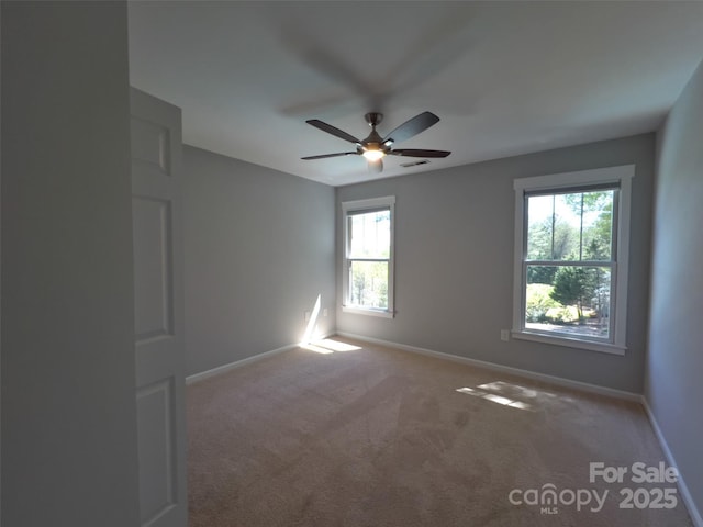 484 Chisholm Trl, Rutherfordton, NC 28139 - carpeted spare room featuring a healthy amount of sunlight, a ceiling fan, and baseboards