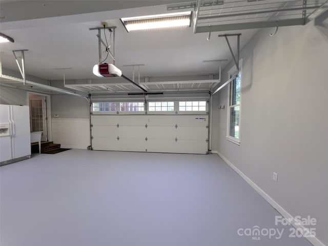 484 Chisholm Trl, Rutherfordton, NC 28139 - garage featuring white refrigerator with ice dispenser and a garage door opener