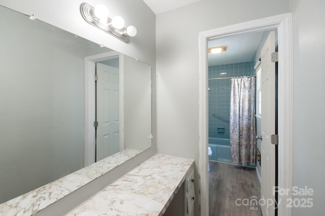 bathroom with vanity, shower / tub combo with curtain, wood finished floors, and toilet