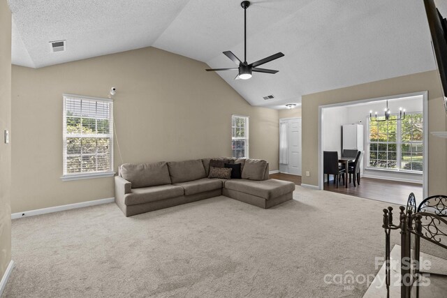 carpeted living area featuring baseboards, ceiling fan, vaulted ceiling, and visible vents