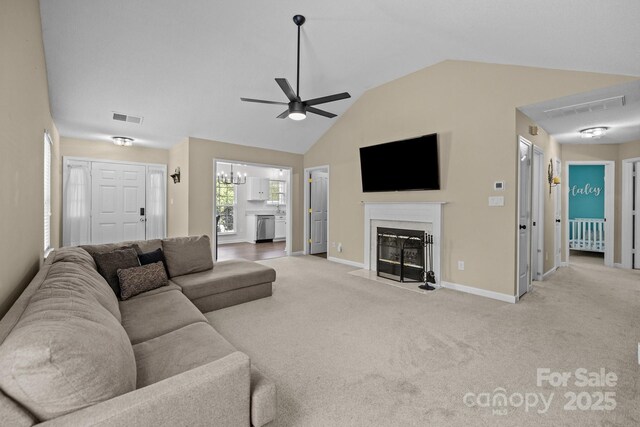 living room featuring visible vents, a fireplace with flush hearth, ceiling fan with notable chandelier, and carpet flooring