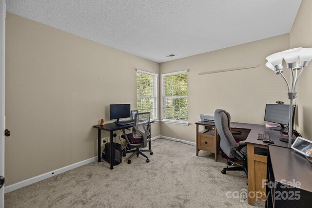 home office featuring carpet flooring, a textured ceiling, baseboards, and visible vents