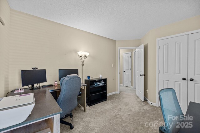 office with carpet floors, a textured ceiling, and baseboards