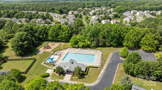 drone / aerial view featuring a wooded view