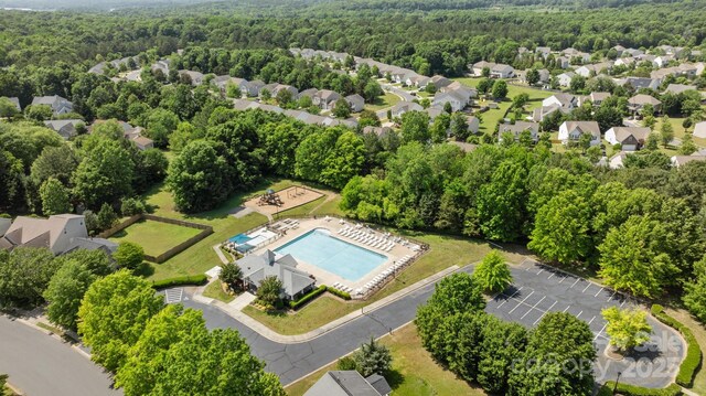 birds eye view of property featuring a view of trees