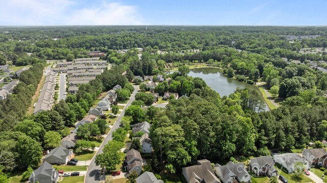 aerial view with a water view, a residential view, and a forest view
