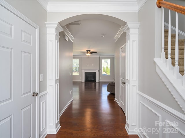 hallway with dark wood-type flooring, arched walkways, ornate columns, and visible vents
