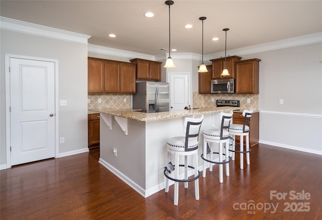 kitchen with brown cabinets, stainless steel appliances, a breakfast bar, and decorative backsplash