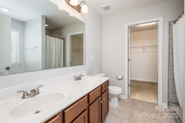full bath with visible vents, a sink, tile patterned floors, and toilet