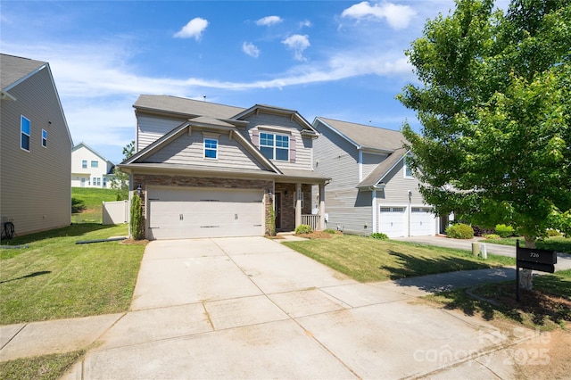 craftsman inspired home with a front lawn and concrete driveway