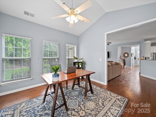 office space with vaulted ceiling, ceiling fan, dark wood-style flooring, baseboards, and visible vents