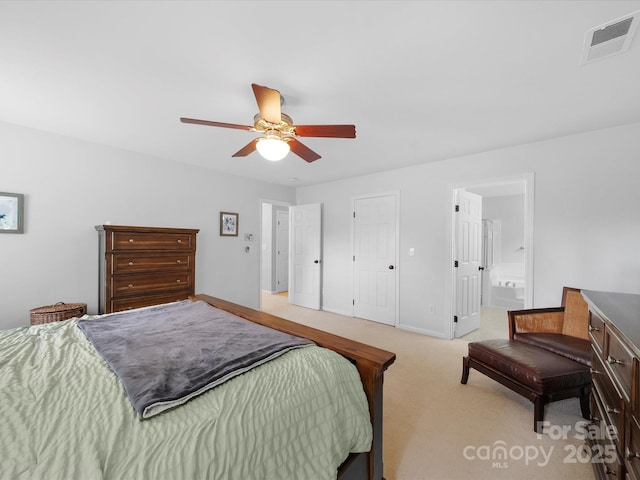 bedroom with connected bathroom, light colored carpet, visible vents, baseboards, and a ceiling fan