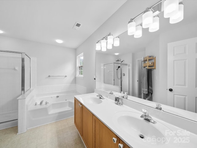 bathroom featuring a stall shower, a sink, a bath, and visible vents