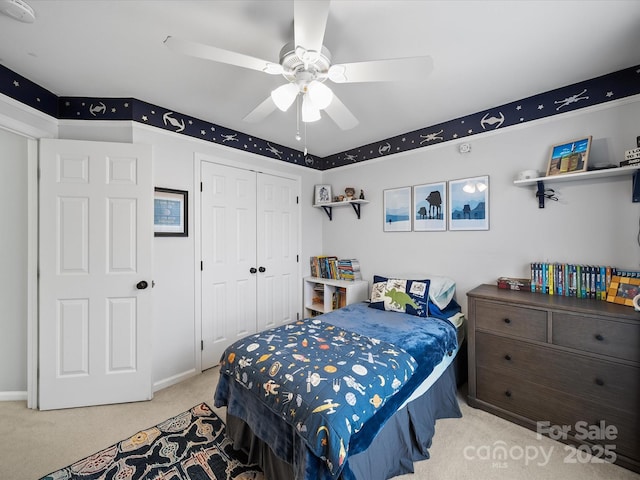 bedroom with a ceiling fan, a closet, and carpet flooring
