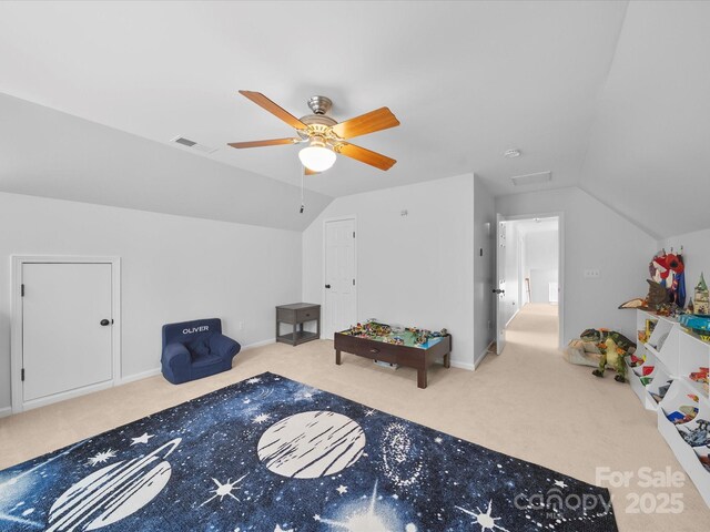 recreation room featuring visible vents, a ceiling fan, carpet floors, and lofted ceiling