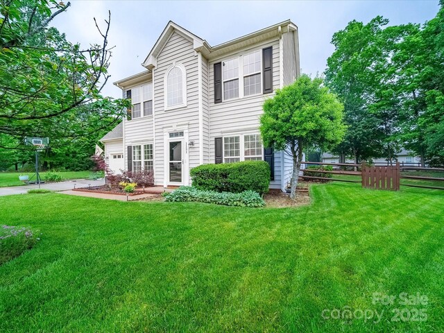 view of front of property with a front lawn and fence