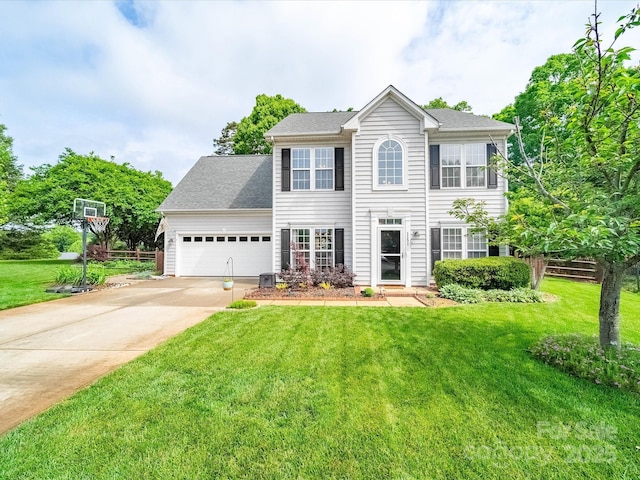 colonial inspired home featuring a garage, a shingled roof, a front yard, and concrete driveway