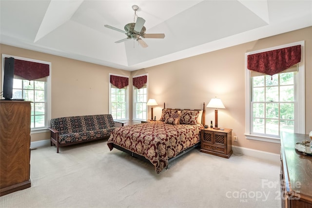 bedroom featuring baseboards, carpet flooring, ceiling fan, and a tray ceiling