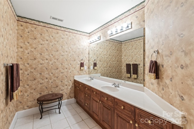 full bathroom featuring a sink, tile patterned floors, double vanity, and visible vents